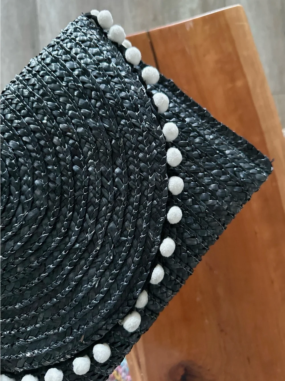 Shiraleah Navy Woven Straw Clutch with White Pom-Pom Trim